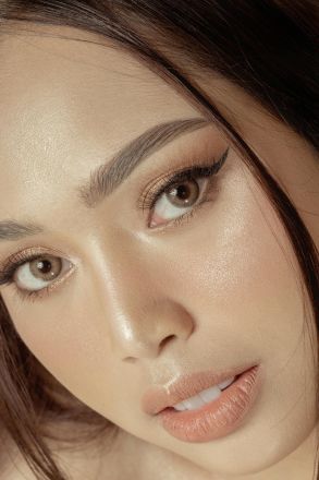 High-resolution close-up portrait of a woman showcasing elegant makeup and eyeliner.